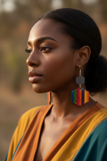 Black woman wearing rainbow clay hexagon drop earrings
