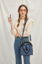 Woman wearing denim cat bag